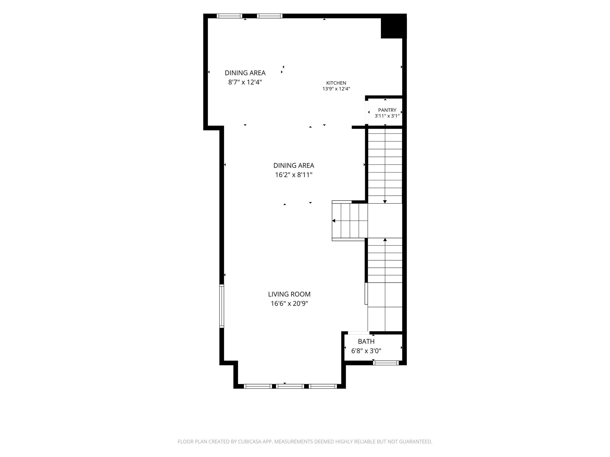 Floor plan showing a kitchen, pantry, two dining areas, living room, bath, and stairs.