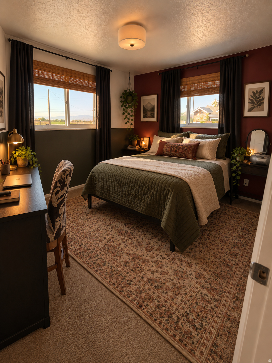 Furnished bedroom with a large bed, patterned rug, burgundy accent walls, and two curtained windows.