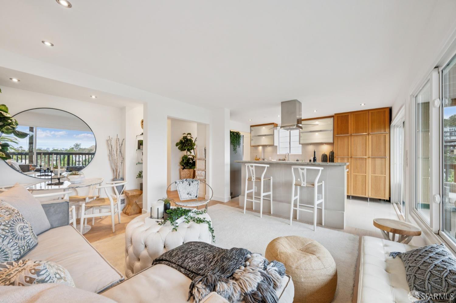 Open-plan living room and kitchen with a large island and distinctive round window.