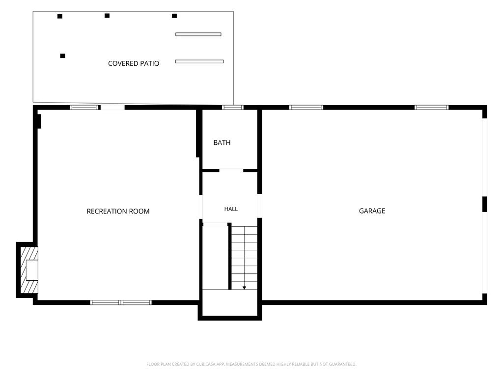 Floor plan with a recreation room, bathroom, hall, garage, and covered patio.