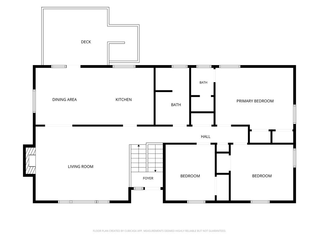 Home floor plan with a deck, open dining and kitchen area, living room, and three bedrooms.