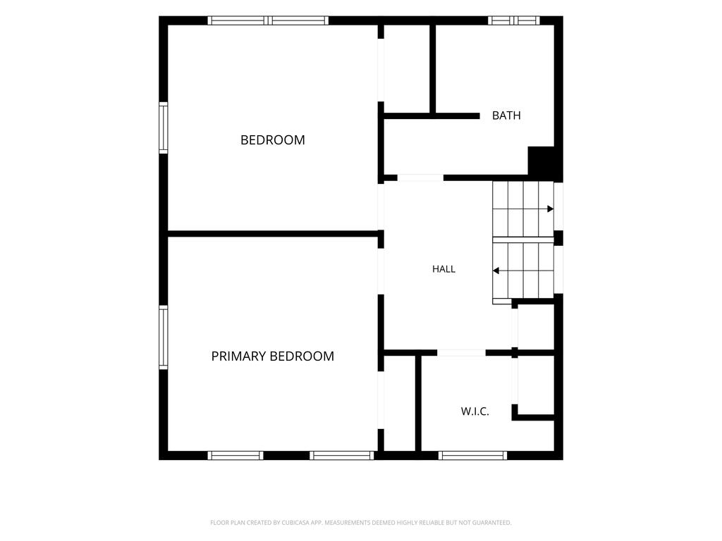Second-floor plan showing two bedrooms, a bathroom, hall, stairs, and walk-in closet.