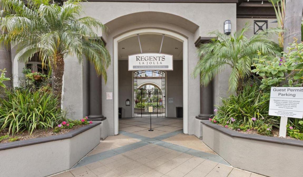 Regents La Jolla entrance framed by palm trees and landscaped planters.