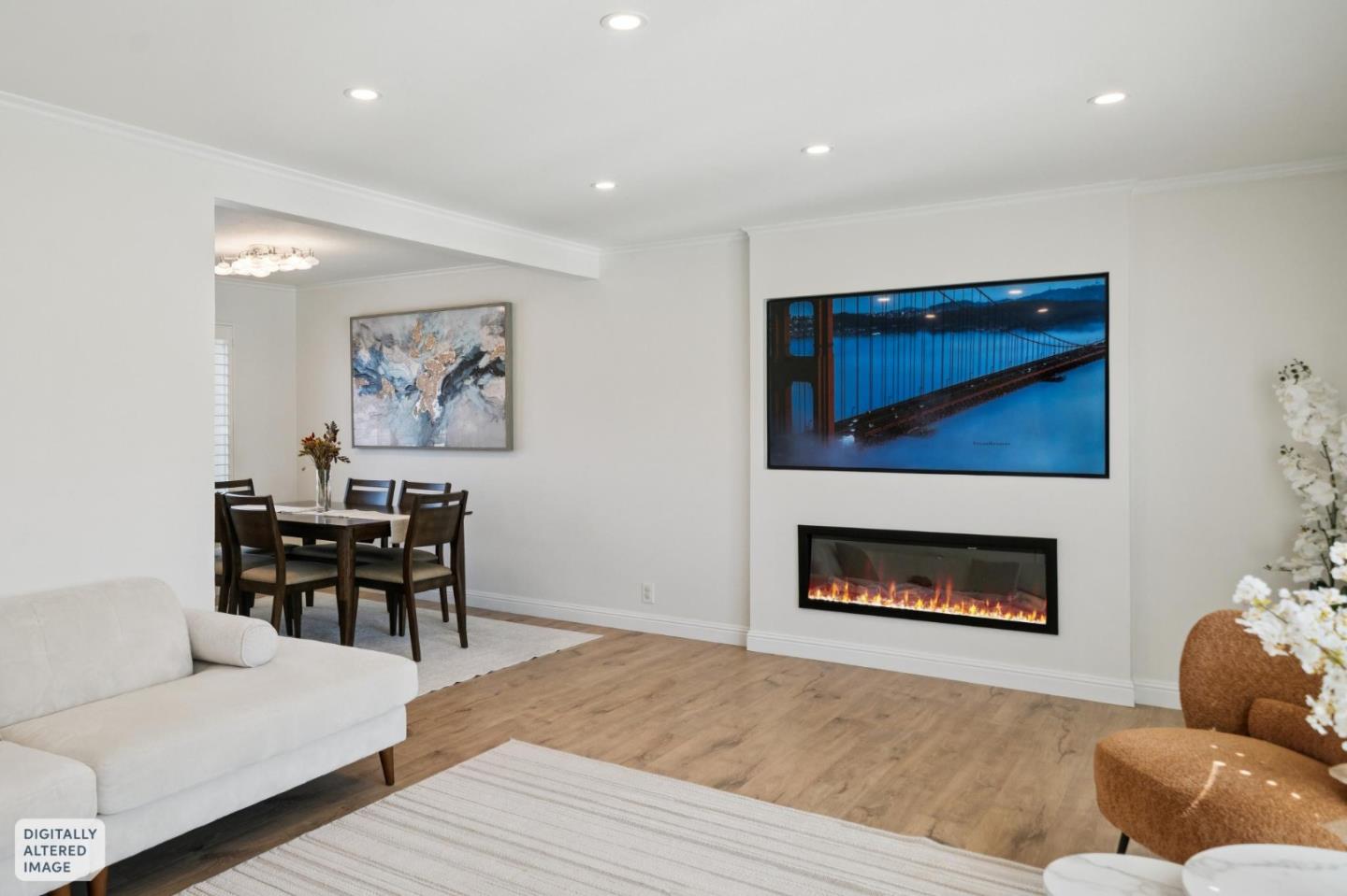 Living room with a built-in fireplace, white sofa, and adjoining dining area.
