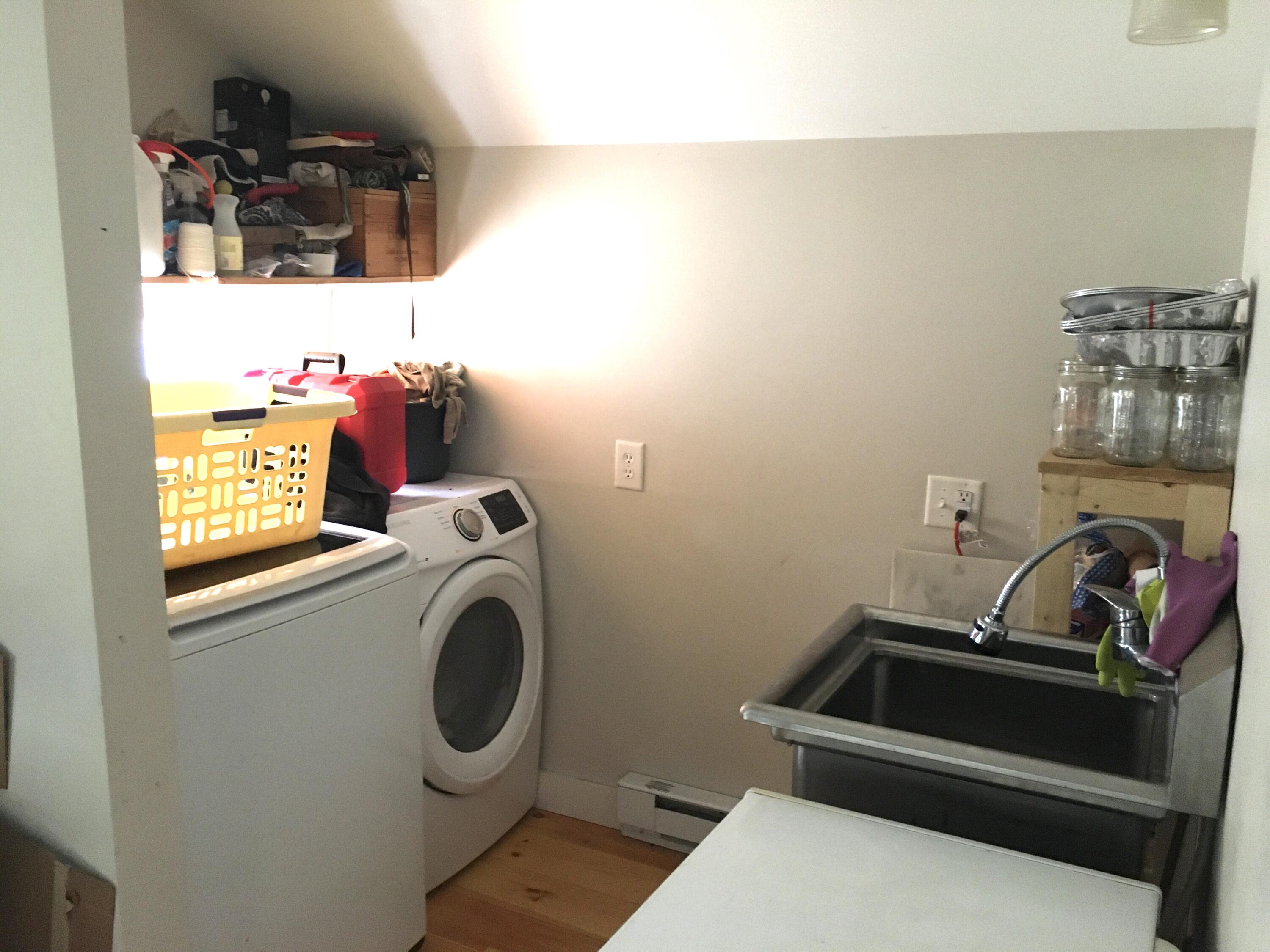 Laundry room with a washer, dryer, and deep utility sink.