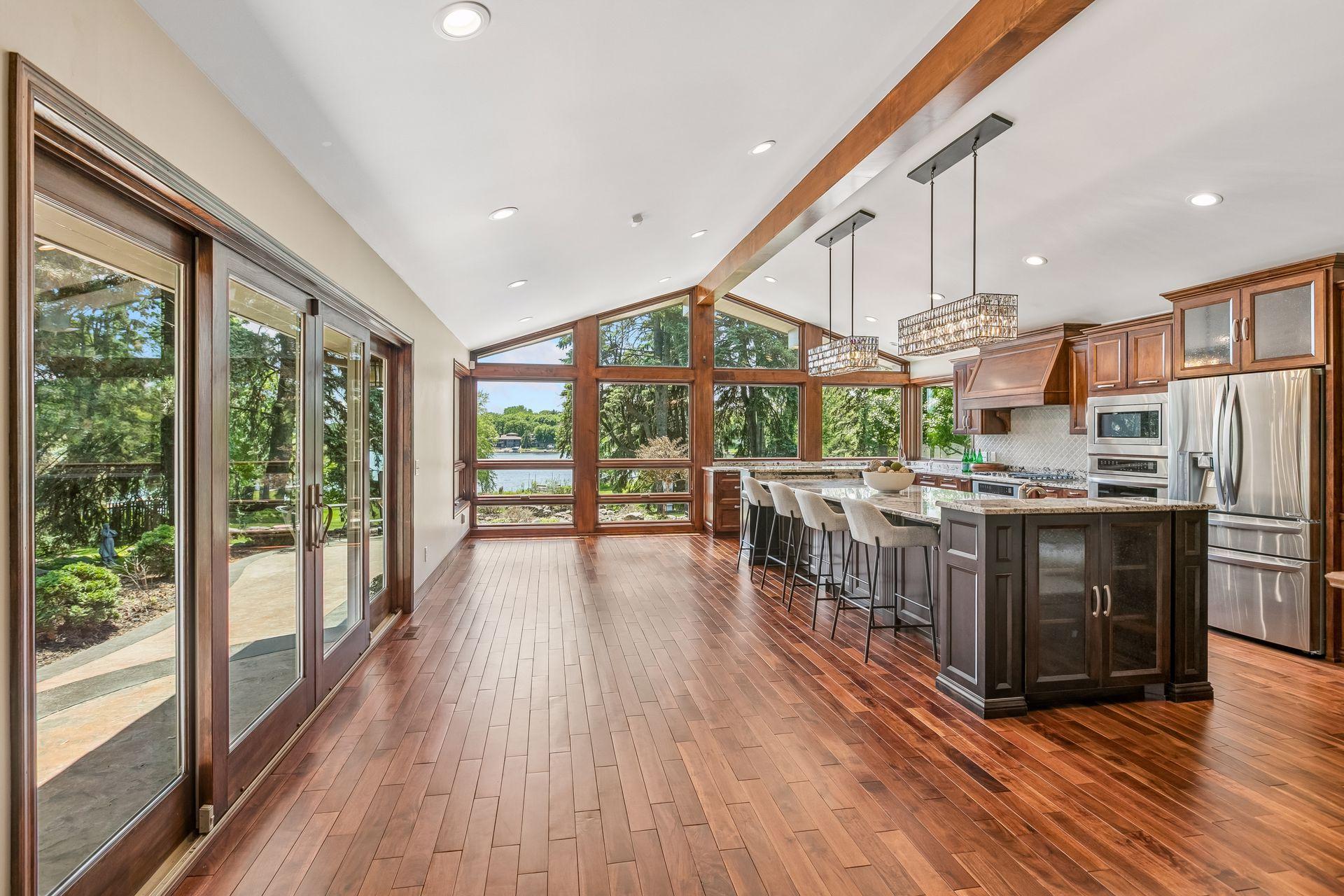 Spacious kitchen with a large island and tall windows overlooking the lake.