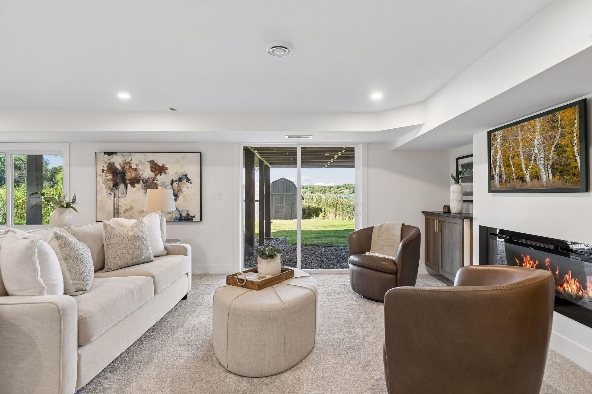 Furnished living room with a fireplace and sliding doors opening toward the lakeshore.