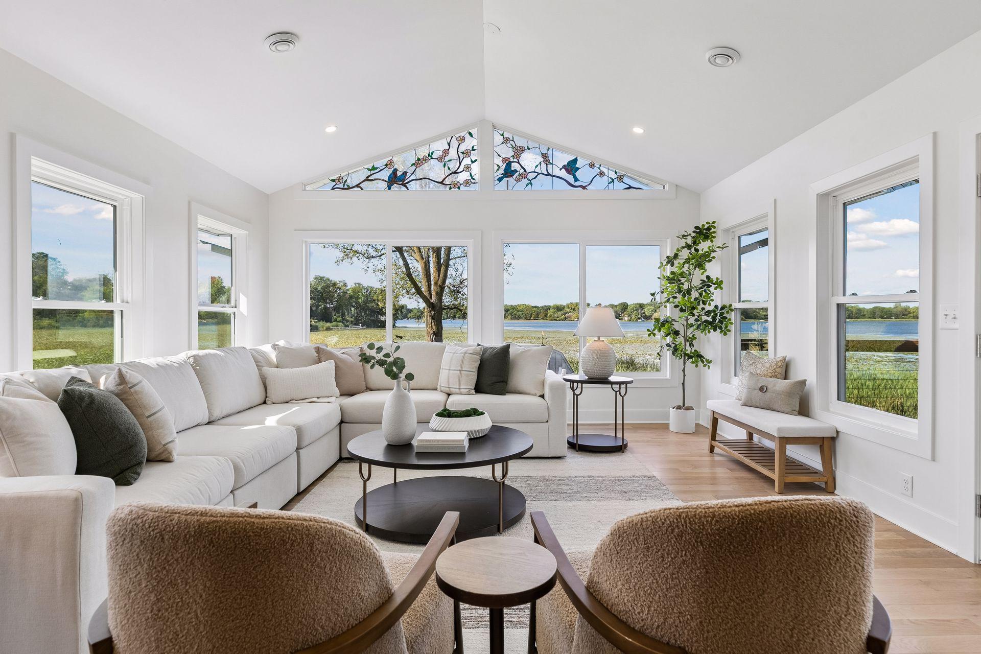 Living room with a vaulted ceiling, stained-glass windows, and broad views of the lake.