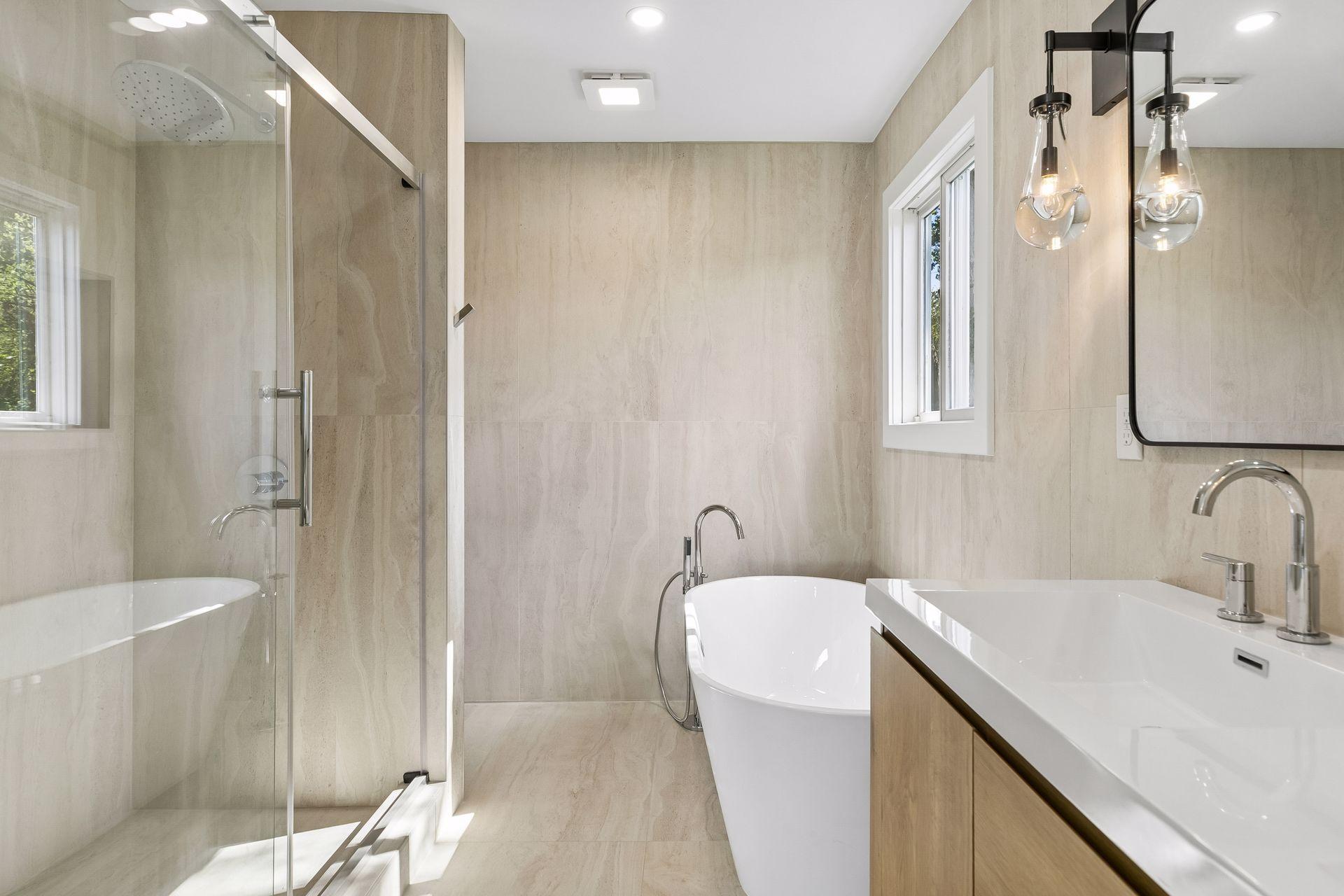 Bathroom with a glass-enclosed shower, freestanding tub, and wood-front vanity.