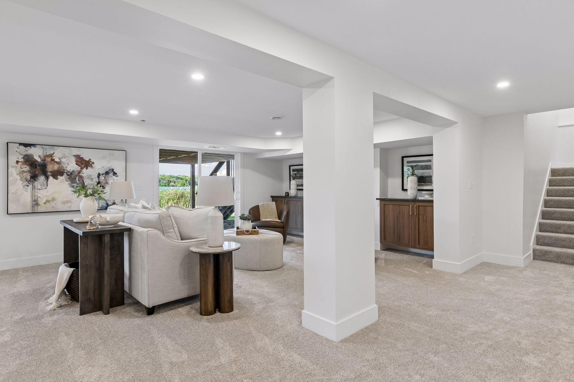 Staged basement living room with a lake view through the sliding glass doors.