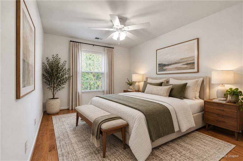 Bedroom with a large white bed, olive accents, a foot bench, and a curtained window.