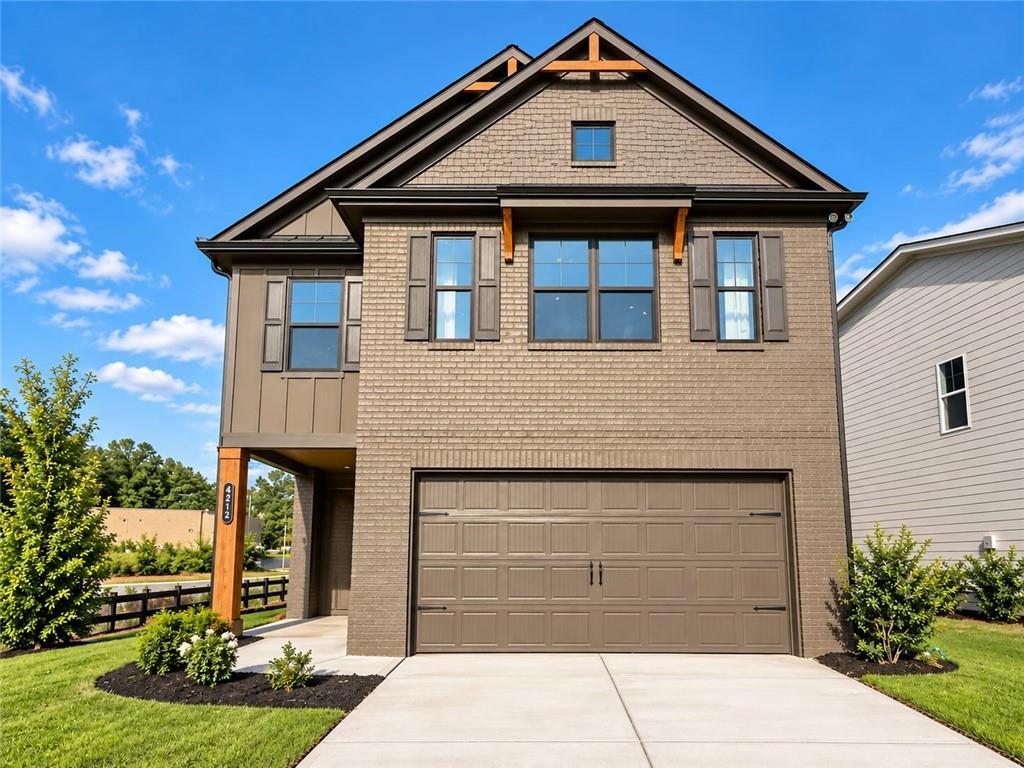 Two-story home with a steep gabled roof, covered entry, and double garage.