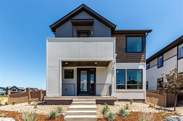Modern two-story house with a covered porch, broad front steps, and gravel landscaping.