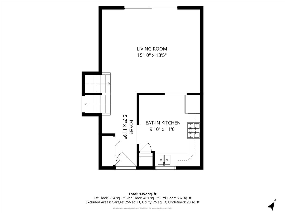 First-floor plan showing a living room, eat-in kitchen, foyer, and stairs.