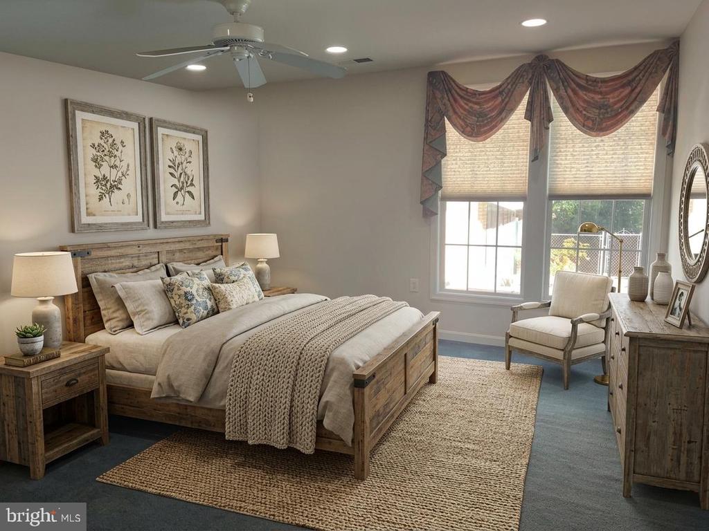 Staged bedroom with a rustic wooden bed, botanical prints, and tall windows with patterned valances.