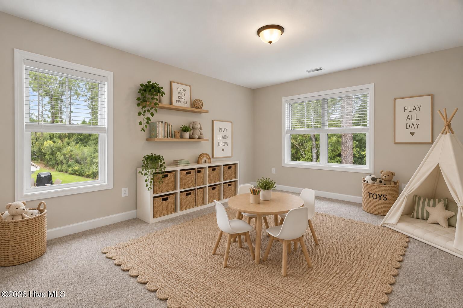 Children’s playroom with a small table, woven storage baskets, and a white teepee.
