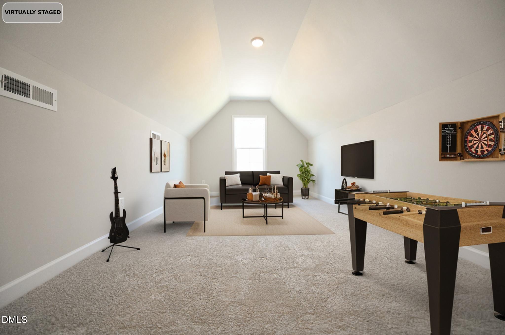 Vaulted bonus room with a foosball table, dartboard, and seating area.