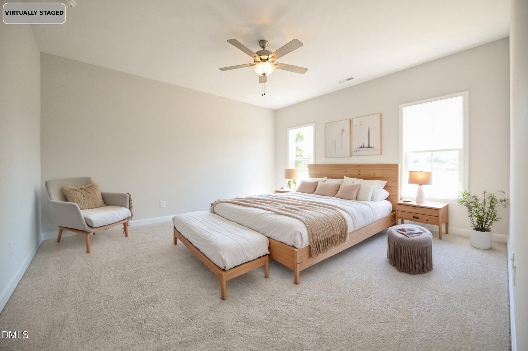 Virtually staged bedroom with a wood bed, matching bench, and upholstered reading chair.