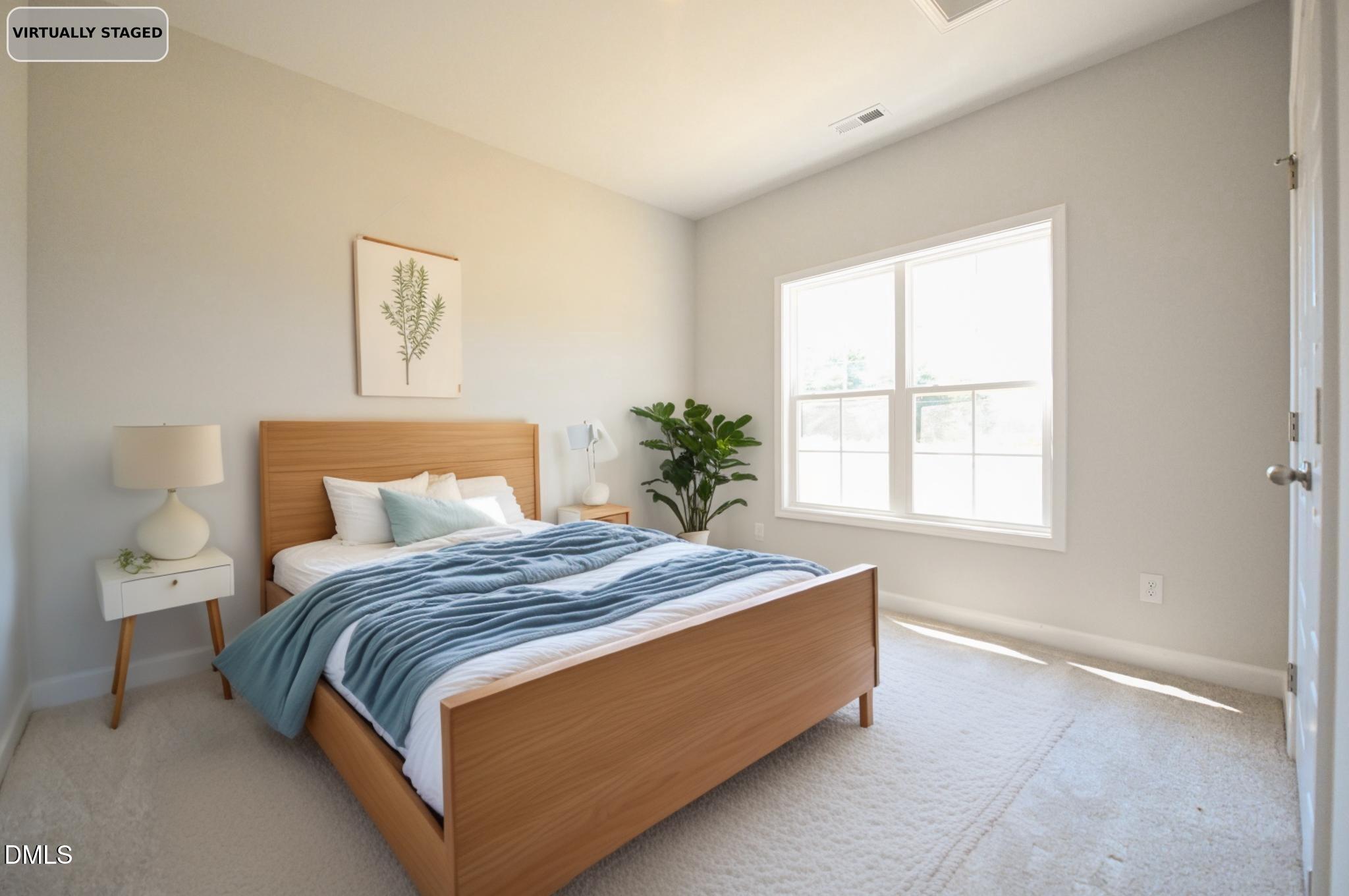 Virtually staged bedroom with a wood bed, blue bedding, and a large bright window.