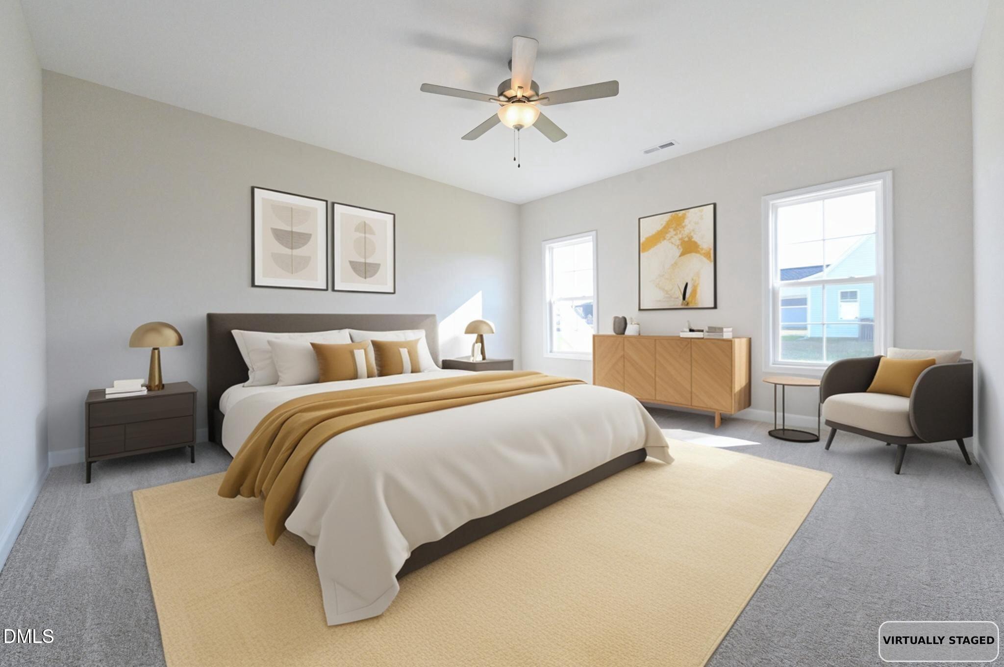 Virtually staged bedroom with a large bed, mustard accents, framed artwork, and a chair beside two windows.