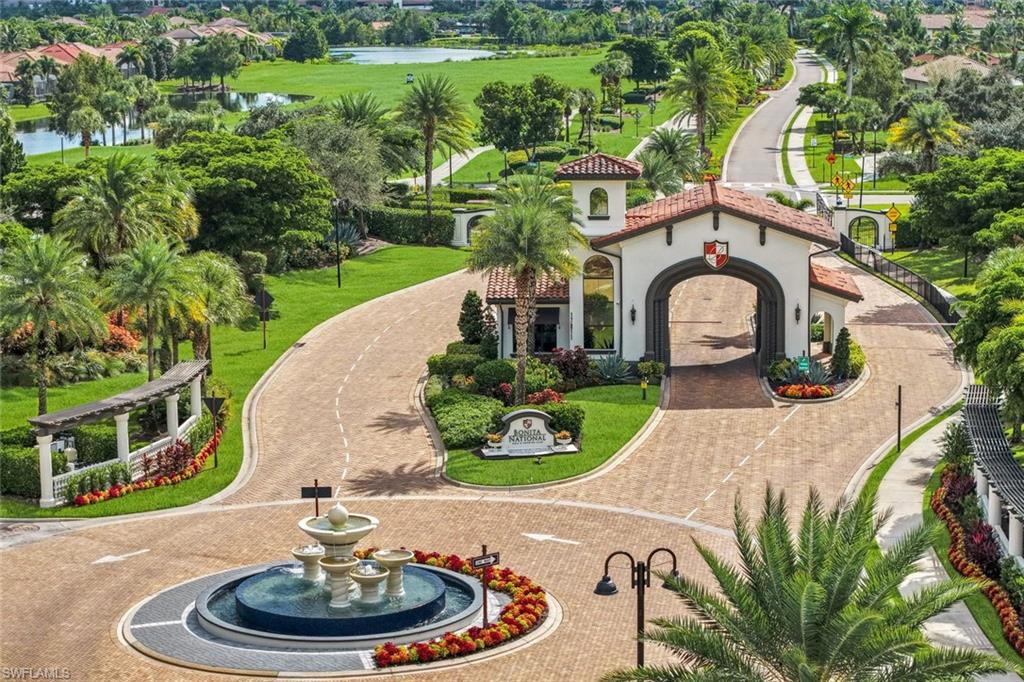 Bonita National community entrance with an arched gatehouse, brick drive, fountain, and landscaped grounds.