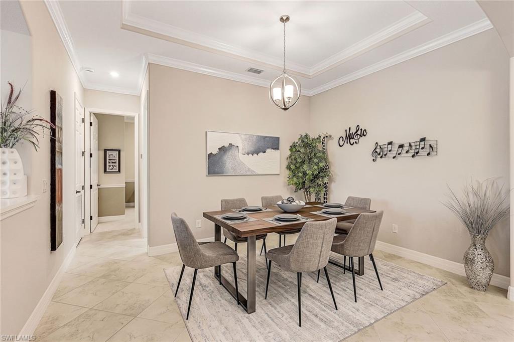 Staged dining room with a set table for six, music-themed wall decor, and marble-look tile flooring.