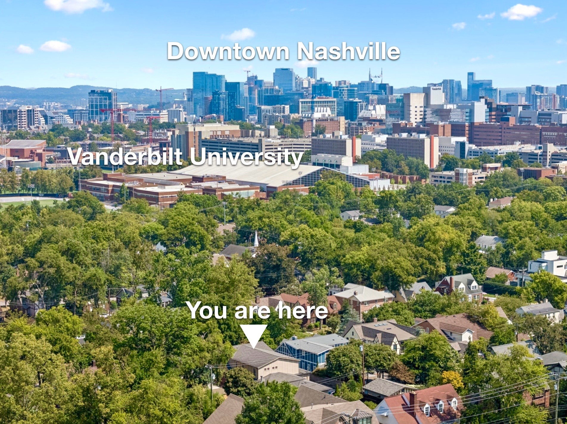 Aerial view of a leafy Nashville neighborhood, with downtown and Vanderbilt University beyond.