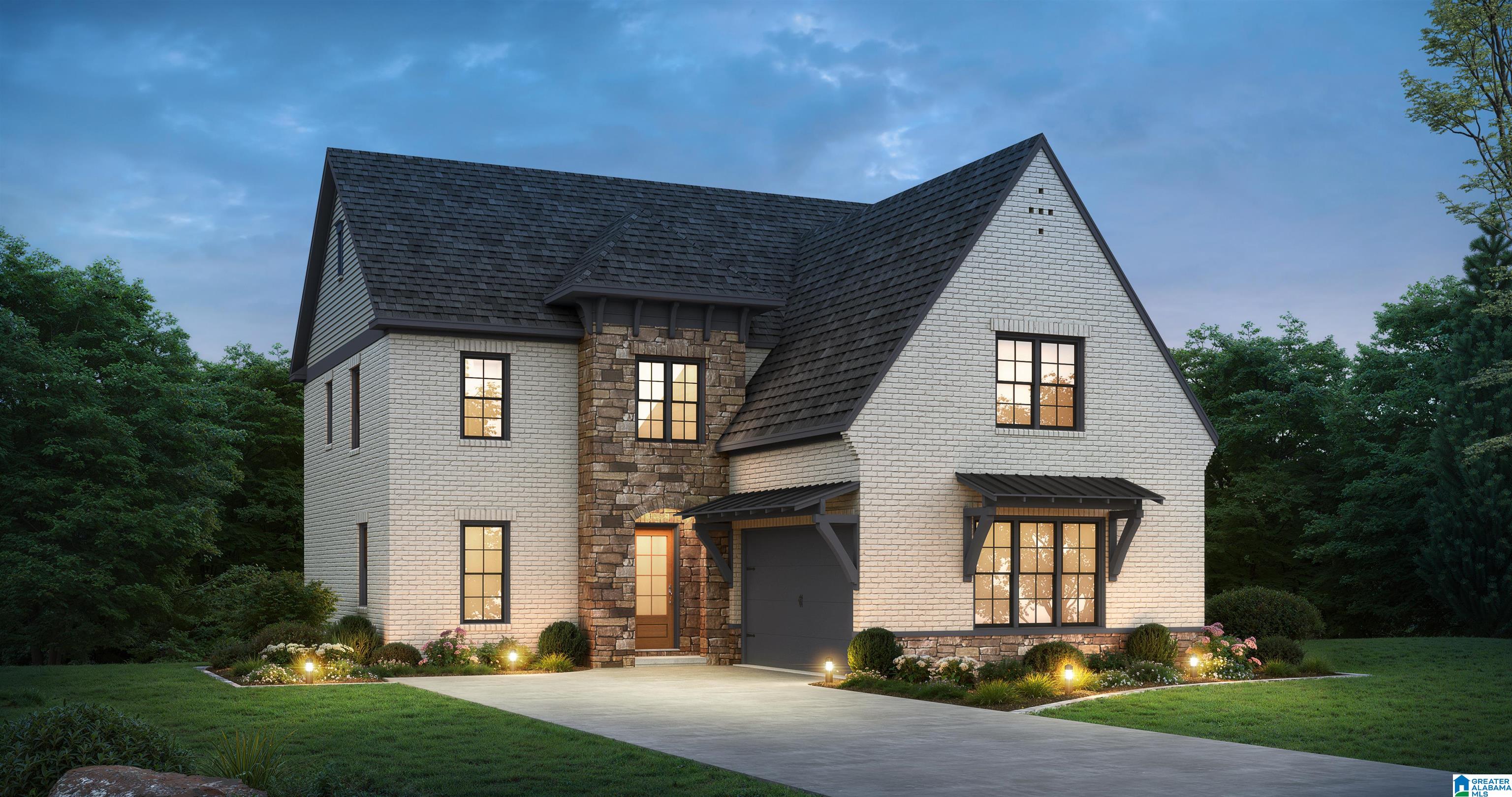 Two-story white-brick home with stone entry, dark gabled roof, and landscaped front yard at dusk.