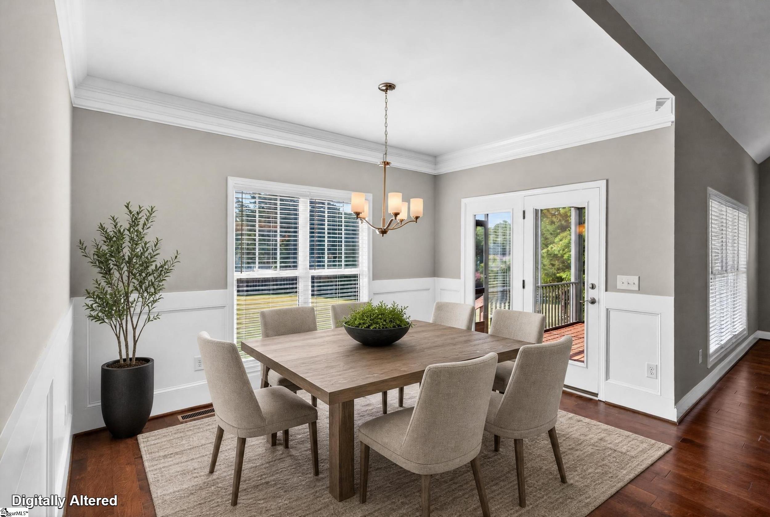 Furnished dining room with a wood table, upholstered chairs, and glass doors opening to a deck.