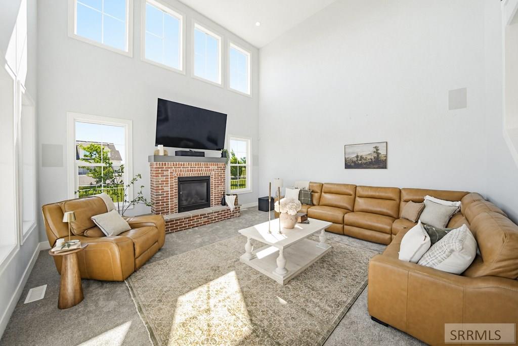 Open concept living room with river views and fireplace, 6268 sq ft estate Shelley ID"