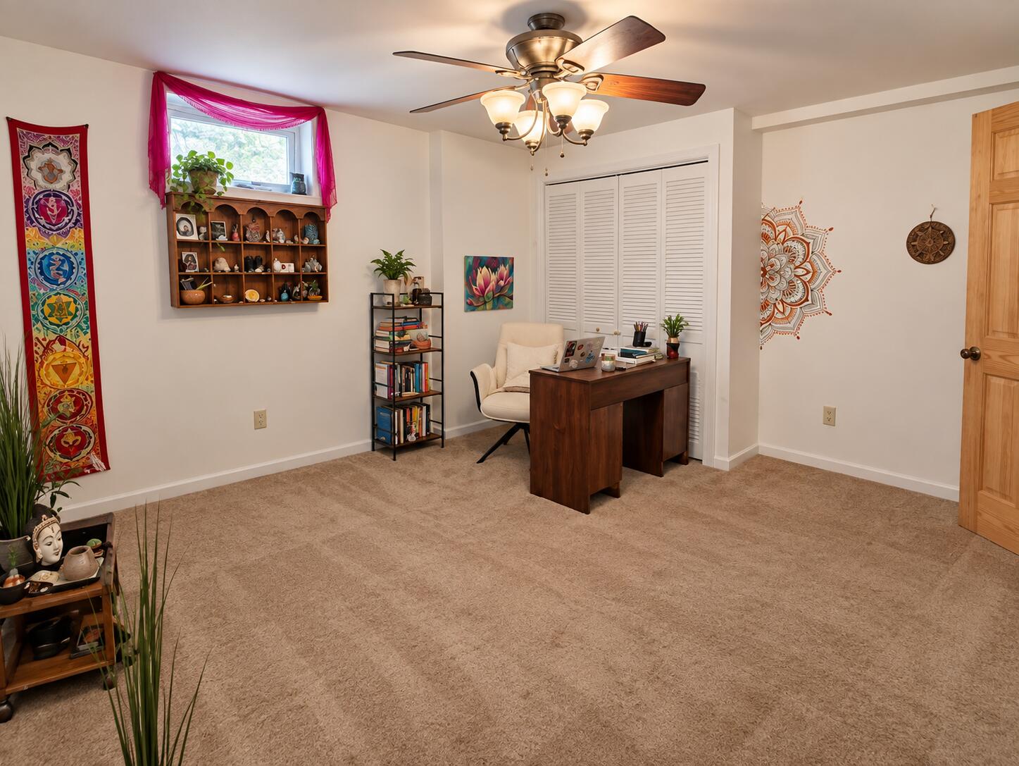 Home office with a dark wood desk, white chair, and colorful wall decor.