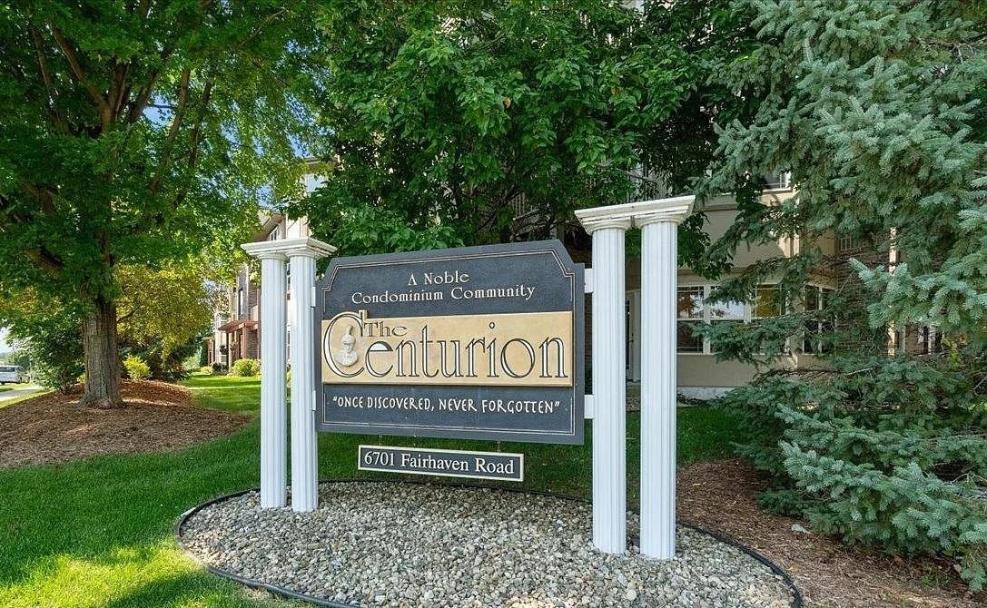 The Centurion condominium community sign at 6701 Fairhaven Road, surrounded by trees and landscaping.