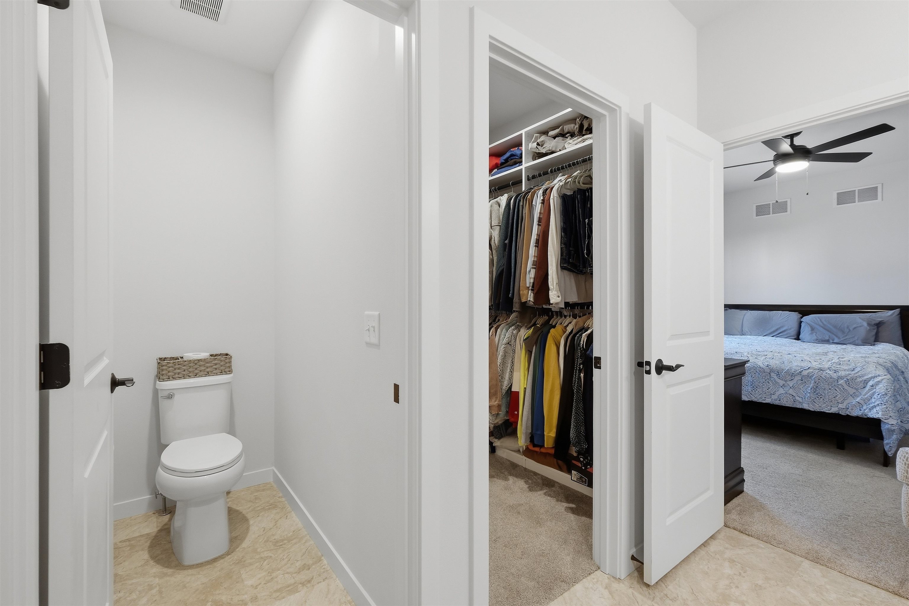 Bedroom suite with a packed walk-in closet between the bedroom and a separate toilet room.