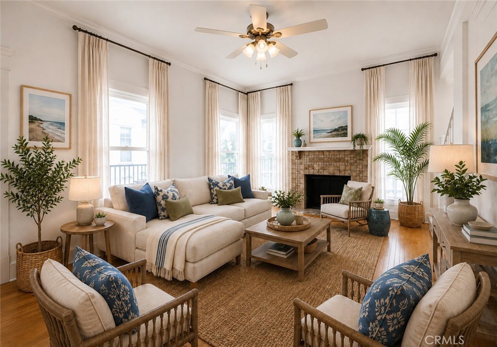 Furnished living room with a cream sectional, tiled fireplace, tall windows, and woven rug.