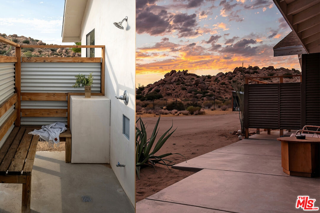 Outdoor shower and patio with a hot tub facing rocky desert hills at sunset.
