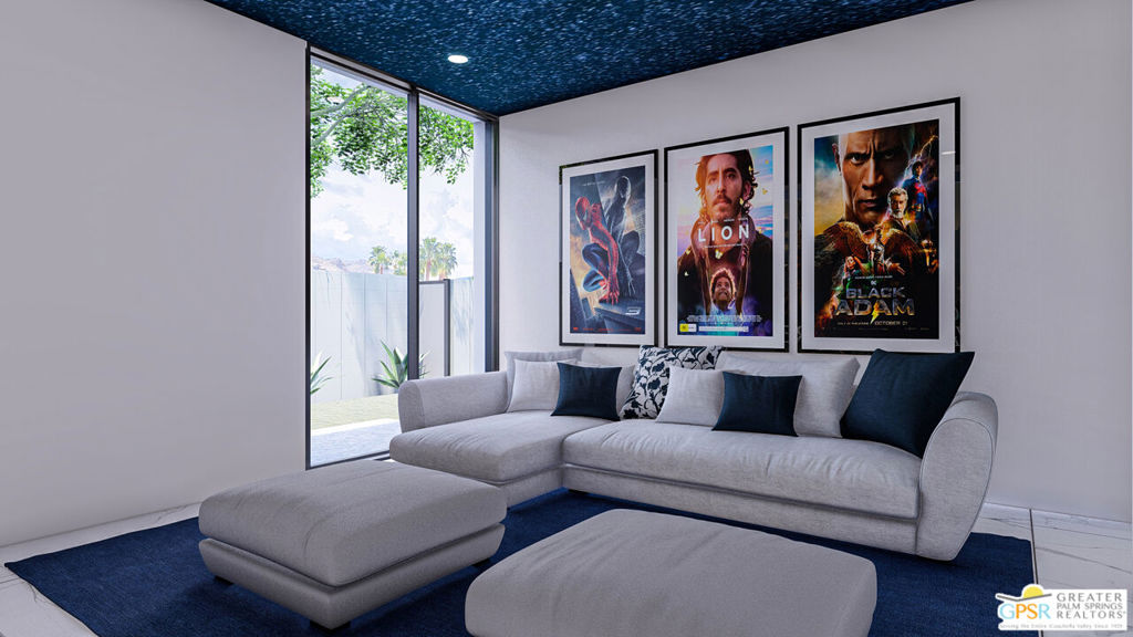 Media room with a gray sectional, three framed movie posters, and tall windows.