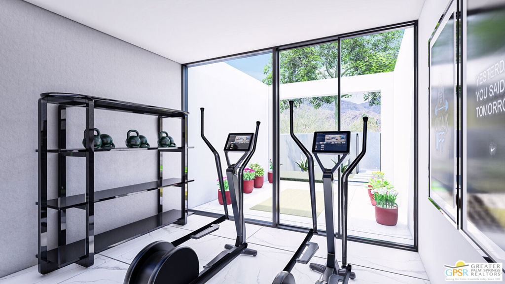 Home gym with cardio machines and kettlebells beside floor-to-ceiling glass doors overlooking a planted patio.