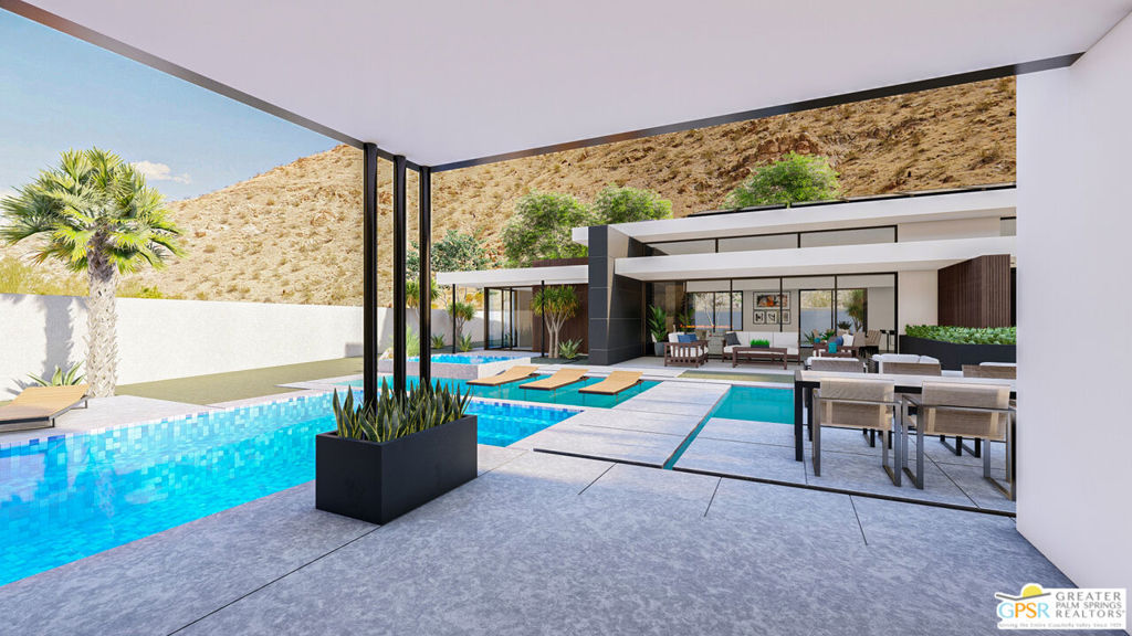 Modern home with a turquoise pool, covered patio, outdoor dining area, and hillside views.