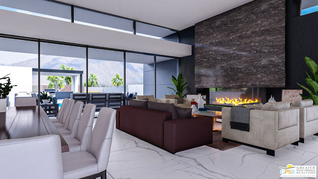 Modern living room with floor-to-ceiling windows, a dramatic stone fireplace, and mountain views.