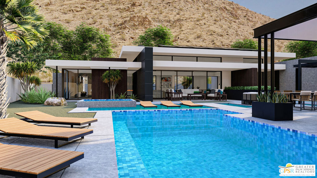 Modern home with a blue-tiled pool, wood loungers, and rocky desert mountain backdrop.