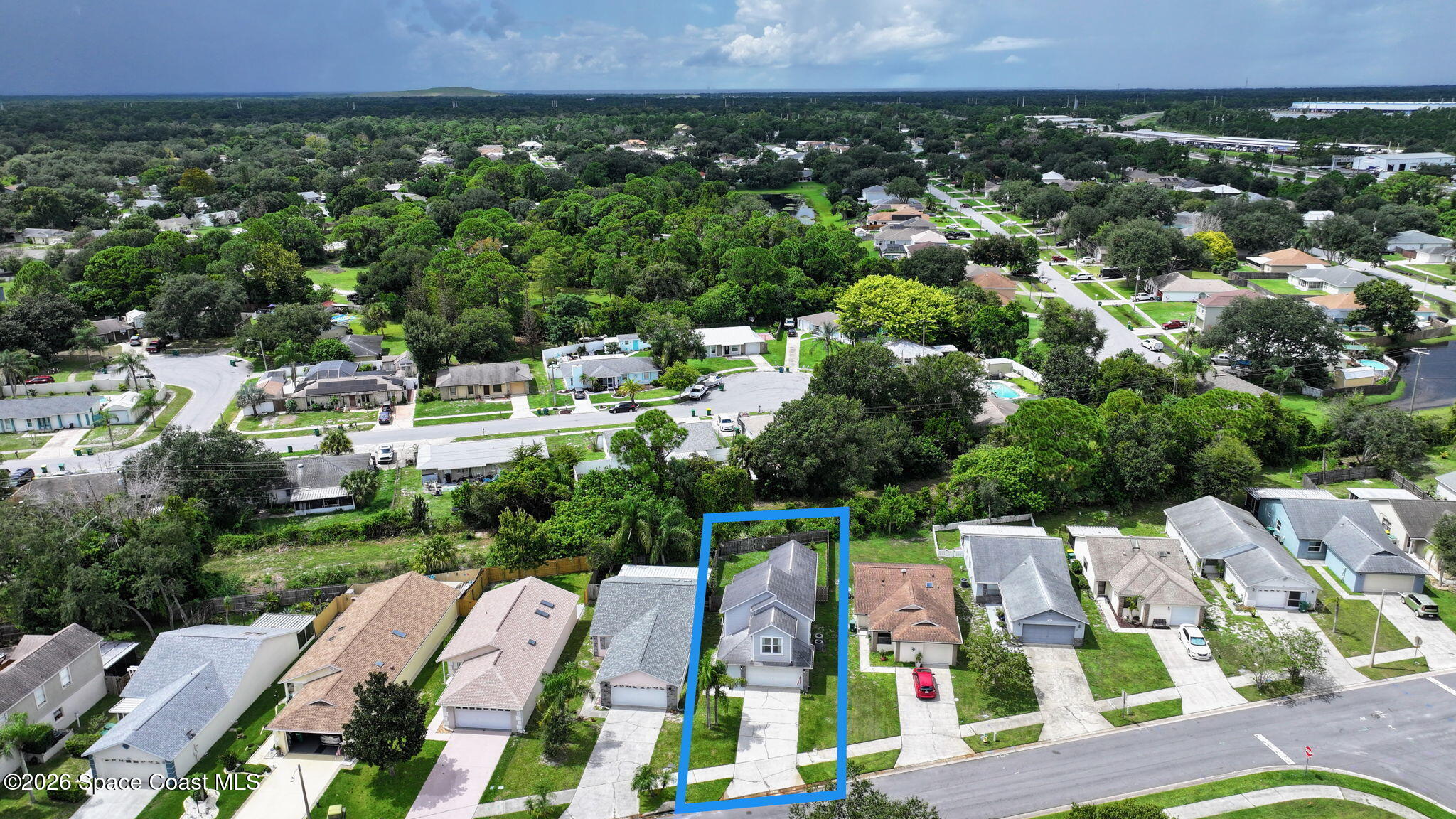 Aerial view of 3039 Dunhill Drive outlined in blue, surrounded by homes and trees.