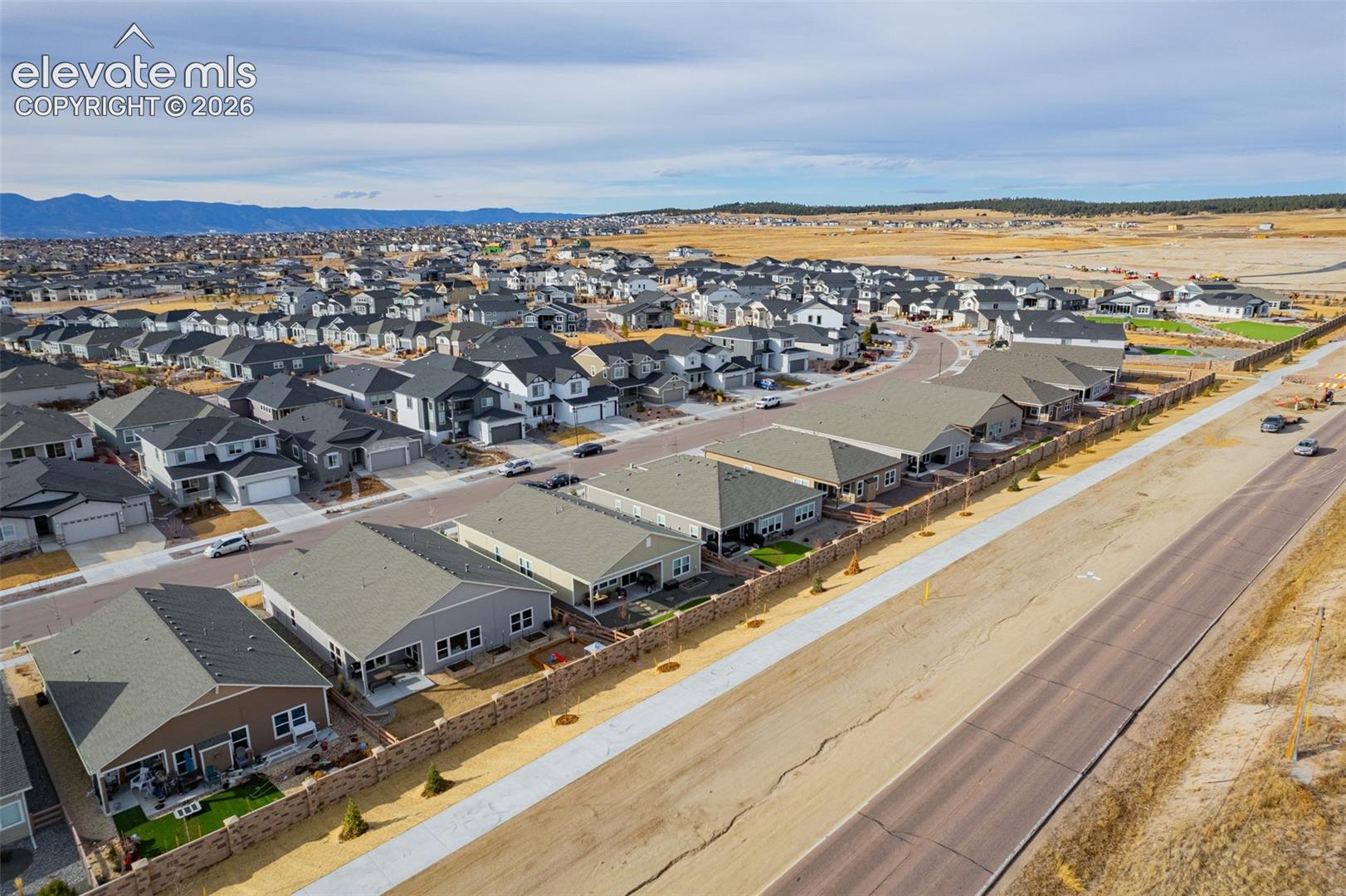 Aerial view of a residential neighborhood with mountains in the distance.