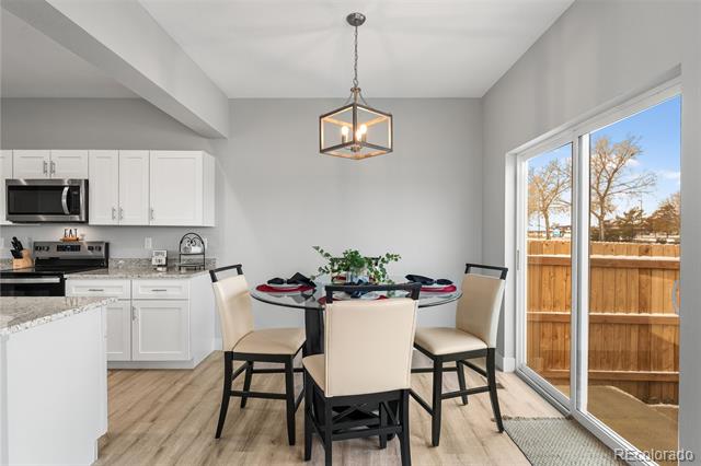 Dining area with a set round table beside the kitchen and sliding glass doors to the yard.