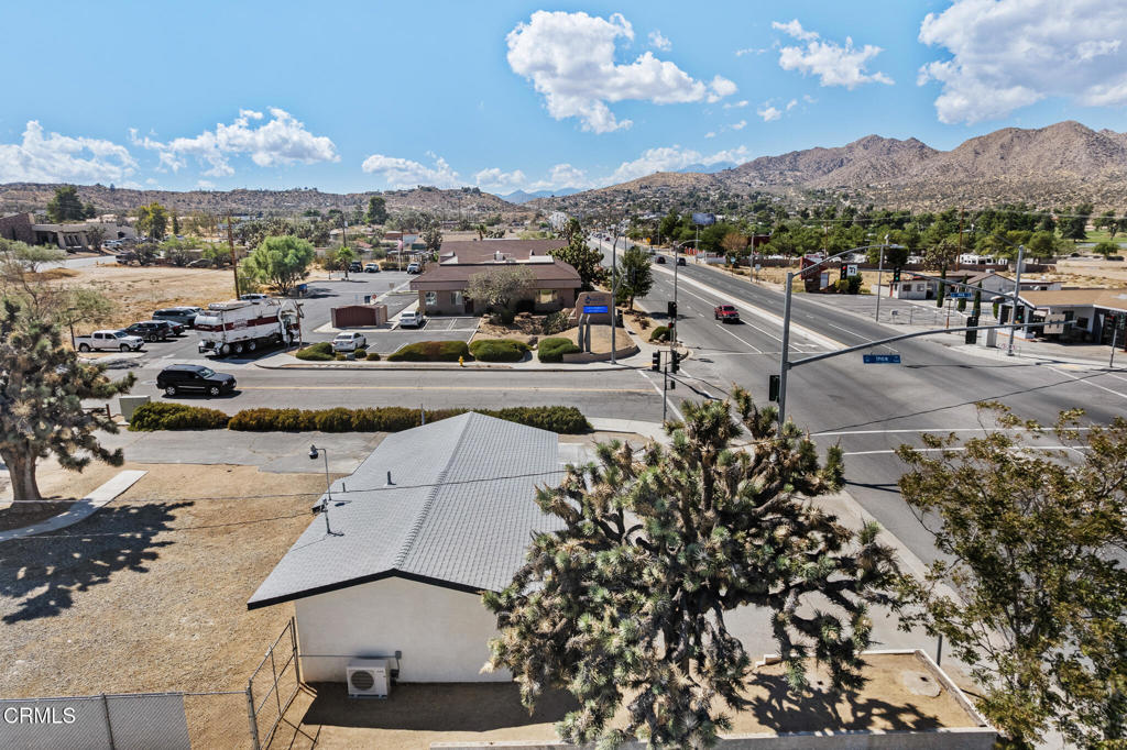 Aerial view of the property beside a highway intersection, with mountains in the distance.