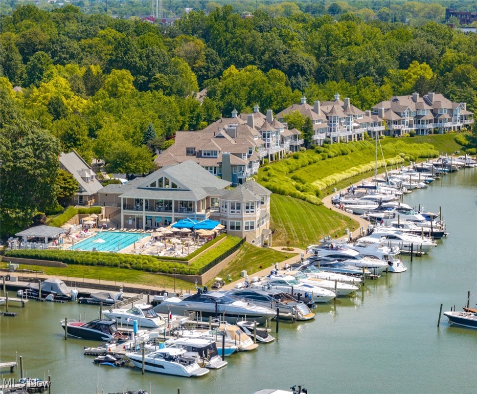 Waterfront community with a marina, swimming pool, clubhouse, and rows of homes.
