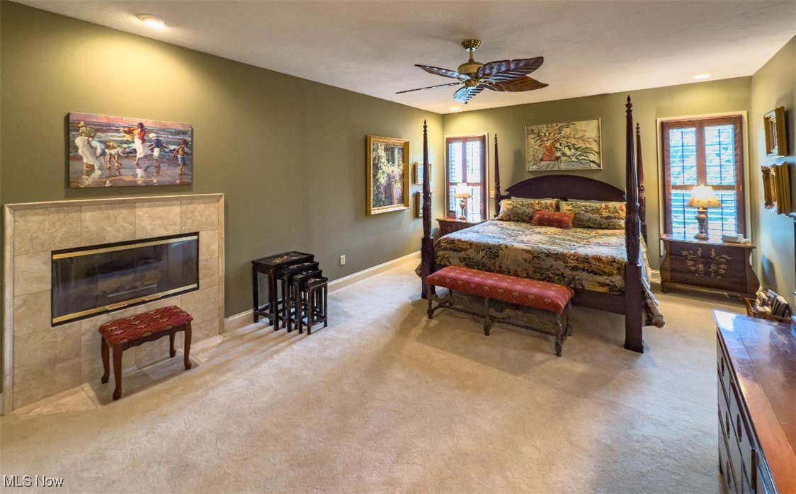 Bedroom with a four-poster bed and stone fireplace.