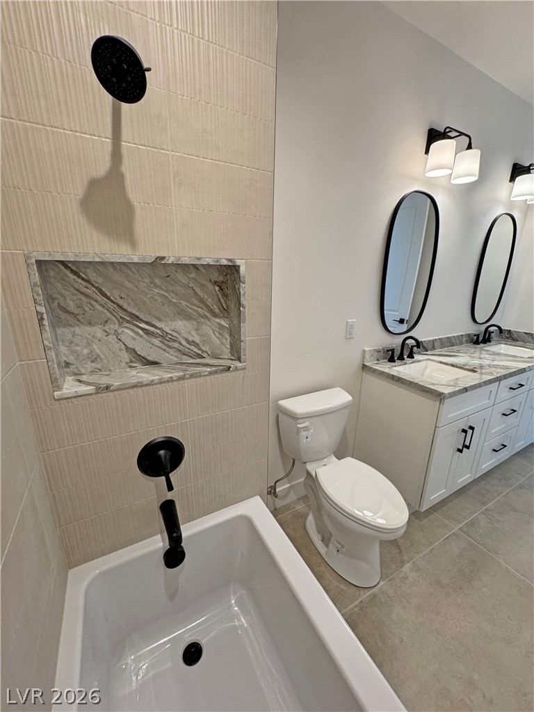 Bathroom with a marble shower niche, black fixtures, and a double vanity.