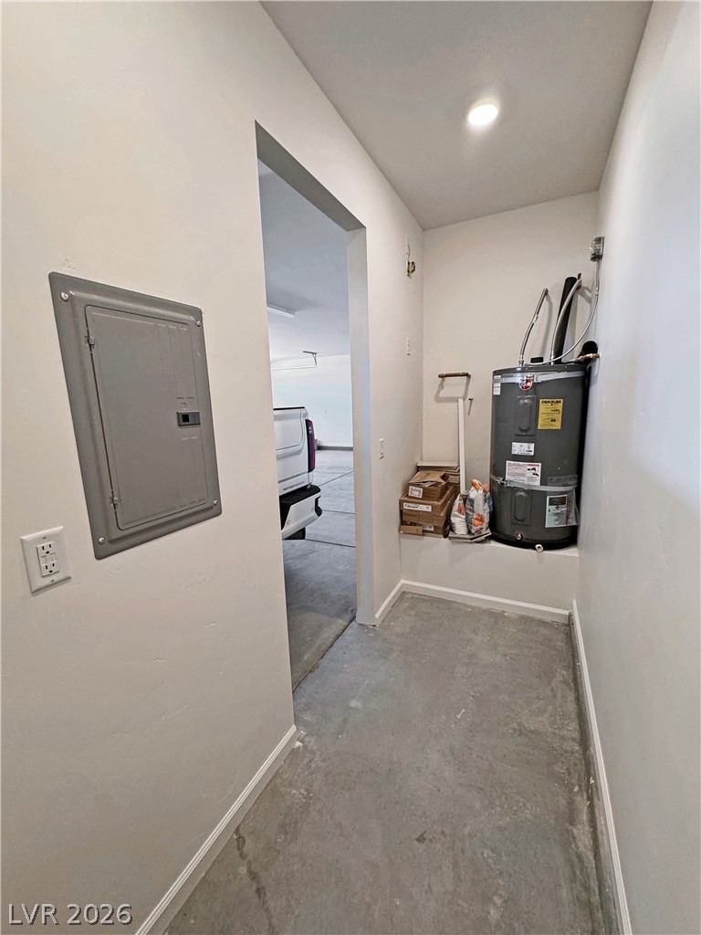 Utility room with a water heater on a raised platform and an electrical panel.