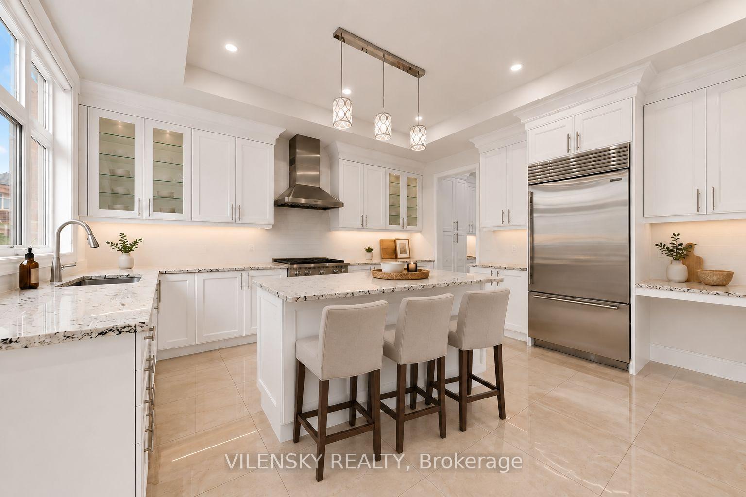 Bright white kitchen with a marble-pattern island, three bar stools, glass-front cabinets, and stainless steel appliances.