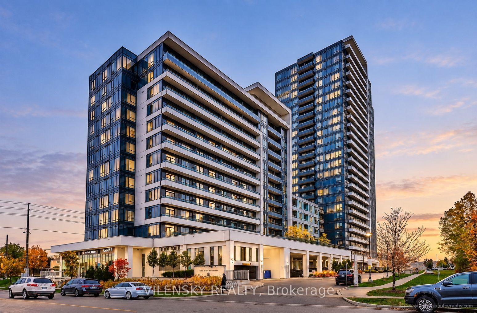 Modern Beverley Glen condominium towers with balconies and ground-floor shops at sunset.